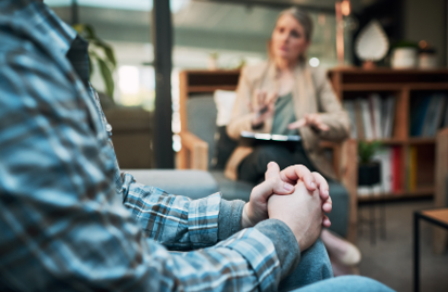 A seated man and woman in deep conversation in a contemporary office