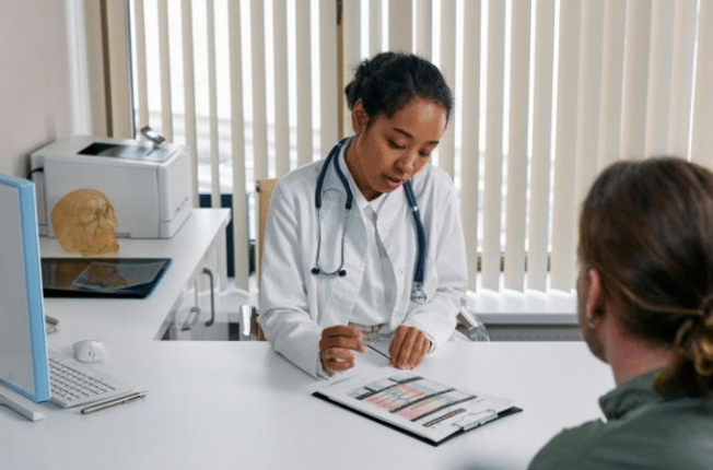Photo of a patient and doctor discussing test results.
