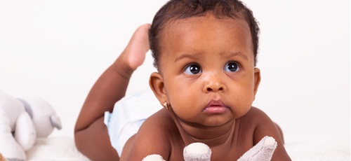 Image of a baby looking at the camera.