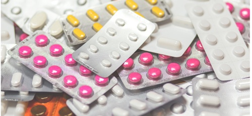 Differently coloured blister packs of medicines.