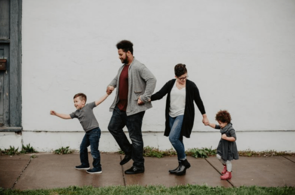 Photo of two parents with their children.