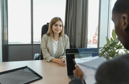 A photo of a person being interviewed at a table