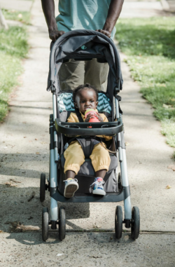 Picture of a toddler in a pushchair.