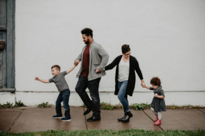 Photo of two parents with their children.