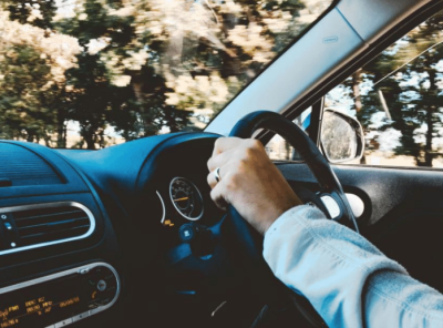 A photo of a person driving a car.